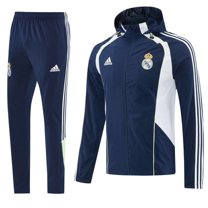 Fato de treino com capuz do Real Madrid 26/27 da marca Velukz, em tecido azul com detalhes brancos.