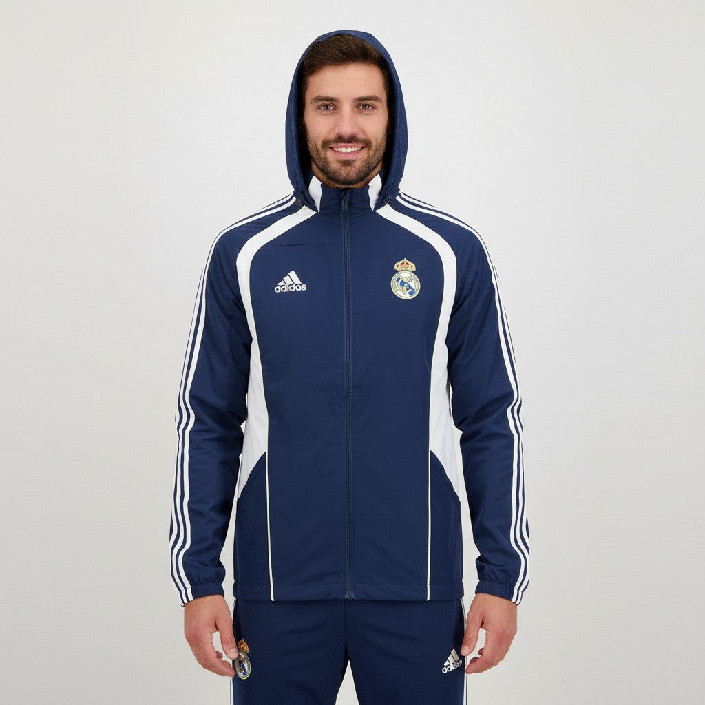 Fato de treino com capuz da Real Madrid 2026/2027, marca Velukz, em tecido azul com detalhes do clube.