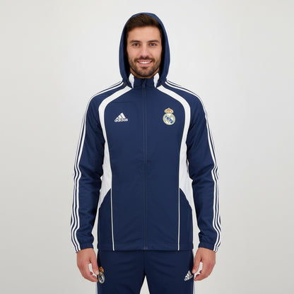 Fato de treino com capuz da Real Madrid 2026/2027, marca Velukz, em tecido azul com detalhes do clube.